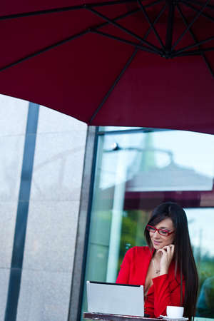 beautiful brunette businesswoman  in outdoors cafeの写真素材