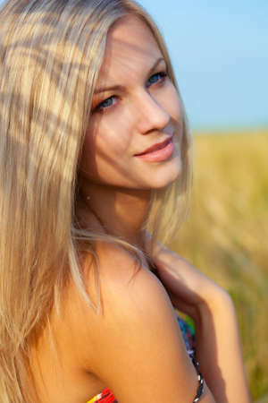 beautiful woman walking on wheat fieldの写真素材
