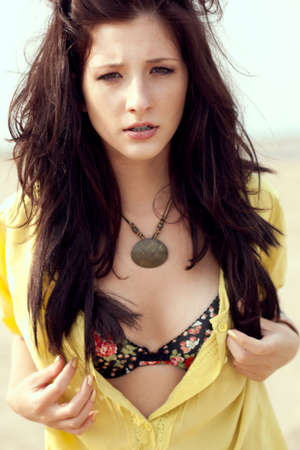 beautiful fashion model woman walking on beachの写真素材