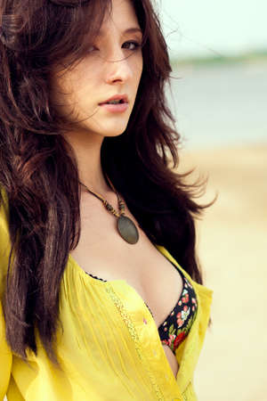 beautiful fashion model woman walking on beachの写真素材