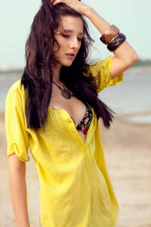 beautiful fashion model woman walking on beachの写真素材