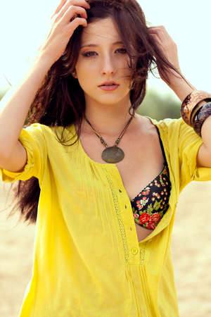 beautiful fashion model woman walking on beachの写真素材