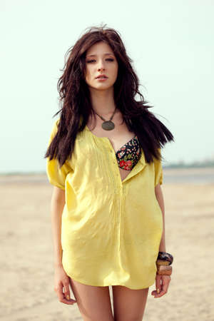 beautiful fashion model woman walking on beachの写真素材