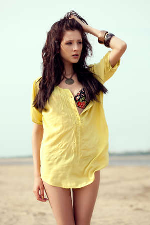 beautiful fashion model woman walking on beachの写真素材