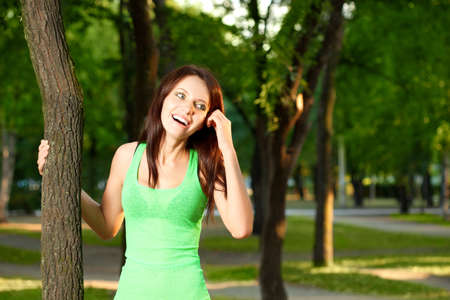 woman walking in the evening summer parkの写真素材