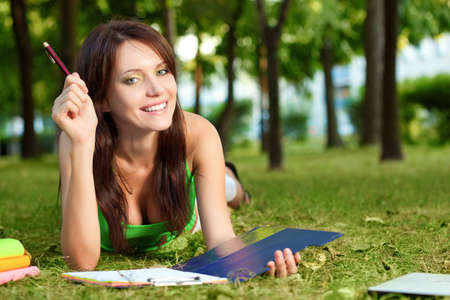 student girl laying on grass  in parkの写真素材