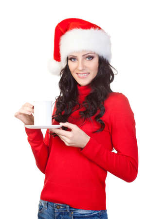 woman wearing santa hat and red sweater holding a coffee mugの写真素材
