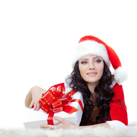 beautiful brunette laying on the floor with giftbox over whiteの写真素材