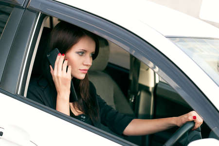 woman in car calling by mobile phone