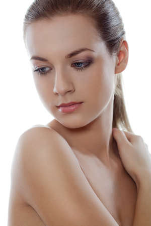beautiful  woman with hand on shoulder over whiteの写真素材