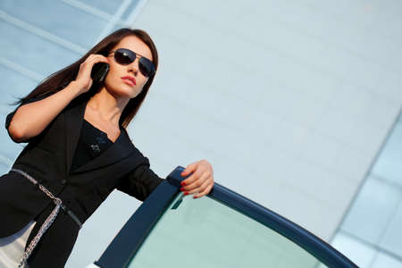 brunette woman calling by mobile phoneの写真素材