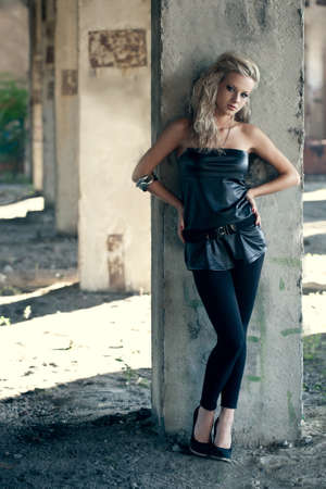 blond woman near column wearing tunic. Fashion photoの写真素材