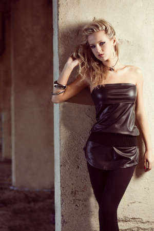 blond woman portrait near column wearing tunic. Fashion photoの写真素材