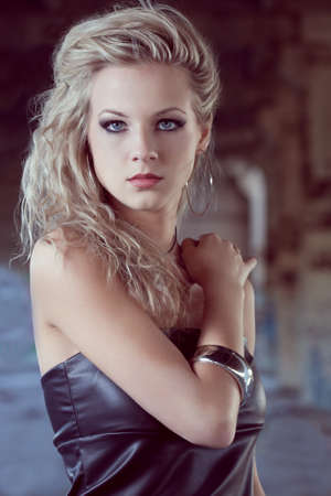 blond woman inside ruins closeup portrait. Fashion photoの写真素材