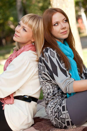 two sisters dreaming in the summer parkの写真素材