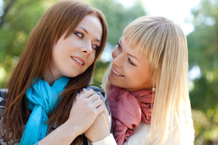 two sisters embracing in the summer parkの写真素材