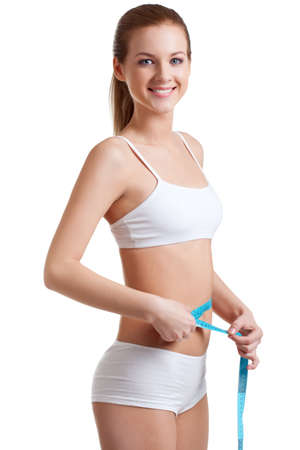 beautiful blonde woman wearing measuring waistlineの写真素材