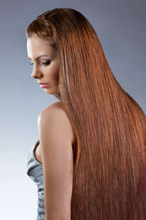 woman with long hair looking down. Studio photoの写真素材