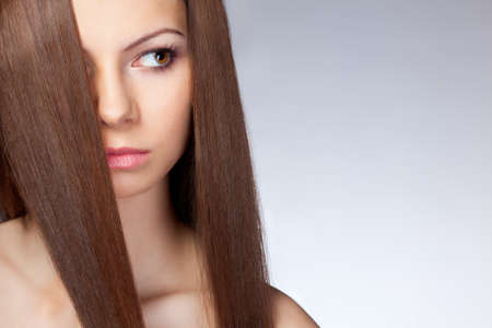 beautiful woman with long hair, closeup face. Studio portraitの写真素材