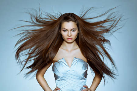 studio portrait of woman with flying hairの写真素材
