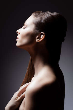 brunette woman profile closeup studio portraitの写真素材