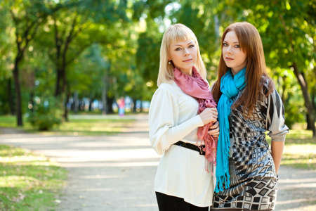 two sisters standing in the summer parkの写真素材