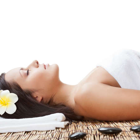 woman laying on bamboo mat in spa salon, closeup viewの写真素材