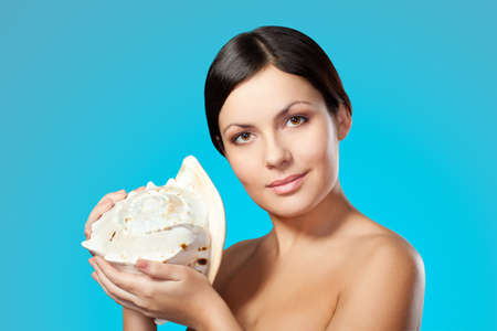 beautiful happy woman holding seashellの写真素材