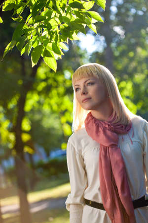 beautiful blond woman walking in the summer park, lens flareの写真素材