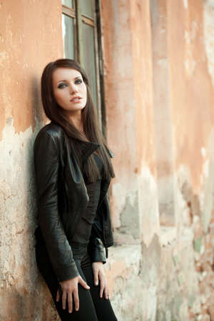 woman near cracked wall looking at cameraの写真素材