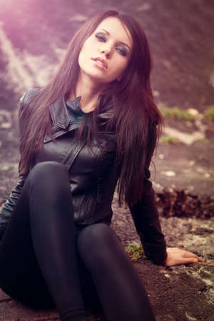 woman portrait wearing leather jacket with lens flare effectの写真素材