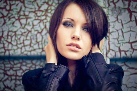 horizontal closeup woman portrait over cracked wall. Specially tonedの写真素材