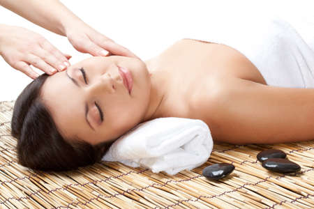 brunette woman in spa salon. Massage of neck and faceの写真素材