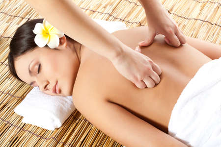 woman receiving back massage at spa salonの写真素材