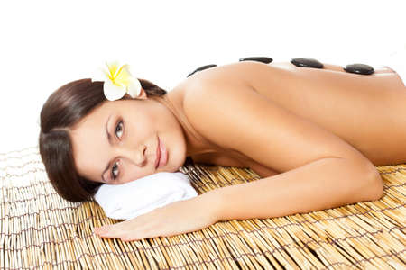 beautiful woman with flower on head in spa salonの写真素材
