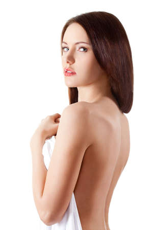 beautiful brunette portrait with white sheetの写真素材
