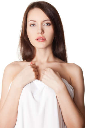 beautiful brunette portrait with white sheetの写真素材