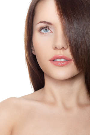brunette woman with hair on eye and shoulderの写真素材