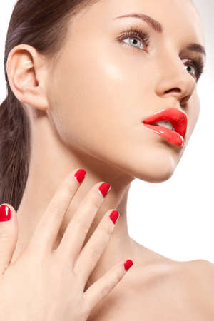 closeup woman portrait with red nails and lipsの写真素材