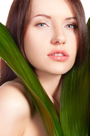 beautitful woman closeup face portrait with green leafの写真素材