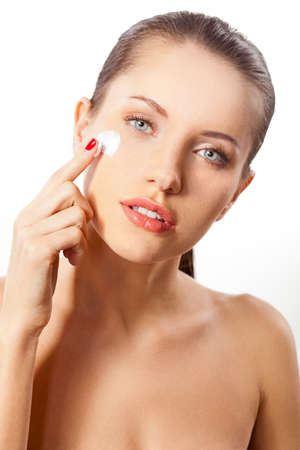 beautitful woman put the cream on the face with fingerの写真素材