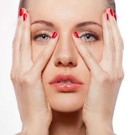 closeup woman portrait with hands on faecの写真素材