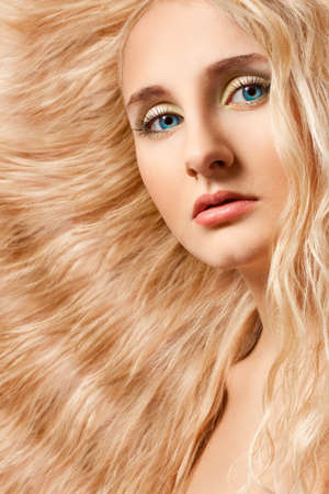 closeup woman portrait with bright blue eyes curly hairの写真素材
