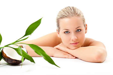beautiful blonde woman   with bamboo and coconut over white backgroundの写真素材