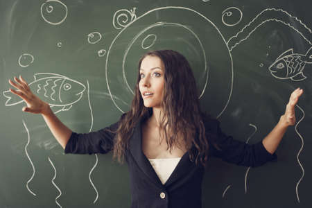 girl over chalkboard with funny painted  diver costumeの写真素材
