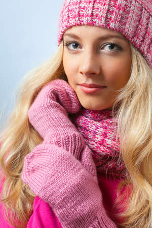 beautiful blonde woman wearing knitwear over blue