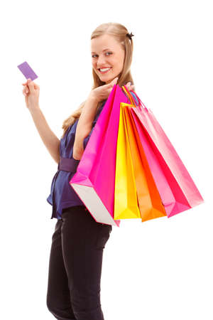 smiling blonde woman with shopping bags and blank  business card over whiteの写真素材