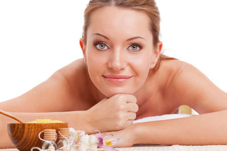 beautiful brunette woman relaxing in spa salon, looking at cameraの写真素材
