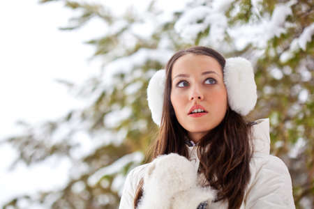 brunette beautiful woman walking in winter parkの写真素材
