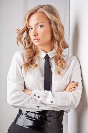 closeup seriously blonde businesswoman portrait near wallの写真素材
